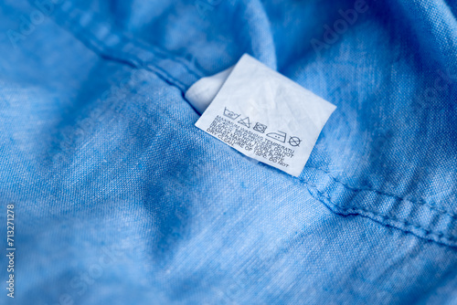 Clothing label on light blue garment, top view