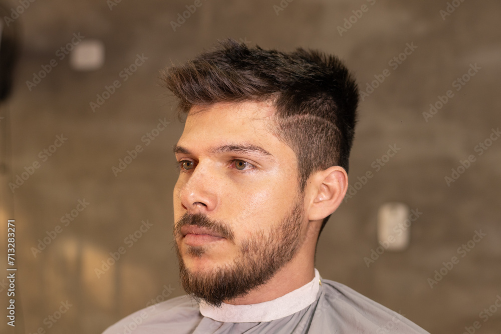 blonde white man with beard getting a haircut in a barbershop blonde white man with beard getting a haircut in a barbershop