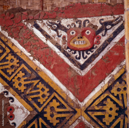 Wall carving of the sun god with face, bird, and snake motif at El Brujo archaeological complex, north of Trujillo in La Libertad province, Peru.