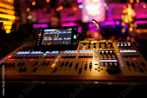 Music sound mixer and technician equipment in a concert hall.