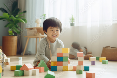 Smiling young child engaged in play with a set of vibrant building blocks on the floor