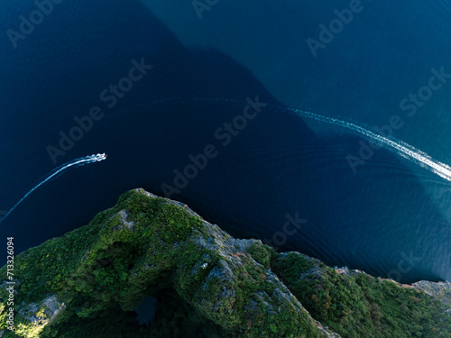 Obraz na płótnie View from above, stunning aerial view of a long tail boat sailing on a blue water near Phi Phi Island. Phuket, Thailand. w salonie