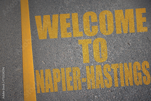 asphalt road with text welcome to Napier-Hastings near yellow line.