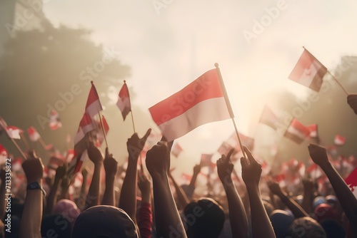A group of people holding small flags of the indonesia in their hands