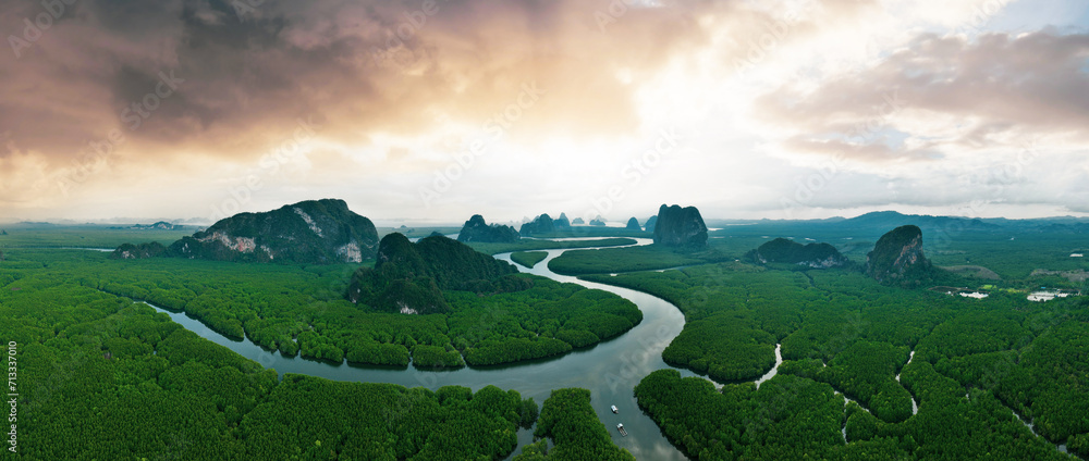 View from above, aerial shot, stunning panoramic view of Ao Phang Nga (Phang Nga Bay) National Park featuring a multitude of limestone formations rising from the sea. Thailand.
