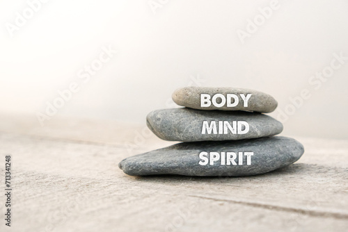 Body  mind and spirit words written on zen stones. Copy space and zen concept