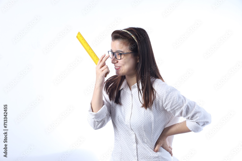 Portrait of a young Indian woman. Indian female teacher. Teach India and literate India. Holding yellow wooden ruler scale in hand. Young Teacher Wearing specs. Portrait of a young Indian woman. Indian female teacher. Teach India and literate India. Holding yellow wooden ruler scale in hand. Young Teacher Wearing specs.