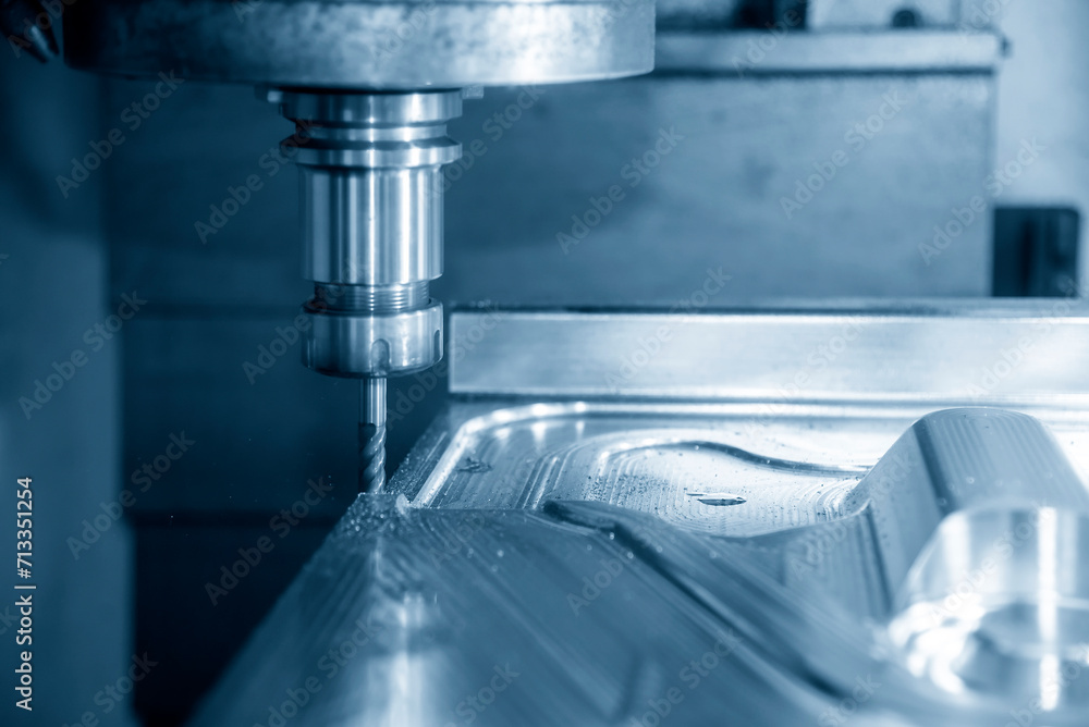 The CNC milling machine cutting press die part by solid bull end mill tool and G-code data background. The CNC milling machine cutting press die part by solid bull end mill tool and G-code data background.