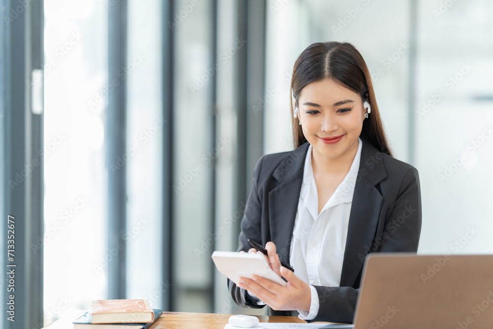 Young happy businesswoman working with tablet and document in corporate office. Young happy businesswoman working with tablet and document in corporate office.