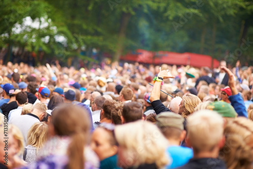 Fototapeta Naklejka Na Ścianę i Meble -  Music festival, crowd and outdoor dancing for celebration event party, listening disco in nature forest. People, concert and social experience for audio carnival performance, audience in summer rave