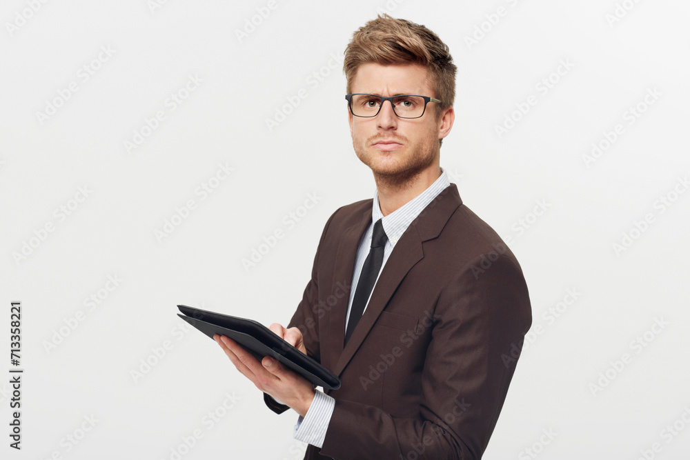 Portrait, tablet and glasses with a business man in studio isolated on a white background for management. Corporate, technology and planning with a serious young employee in eyewear for research Portrait, tablet and glasses with a business man in studio isolated on a white background for management. Corporate, technology and planning with a serious young employee in eyewear for research