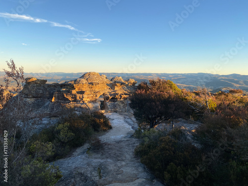 Arched cave entrance. Spectacular views from a mountain-top lookout. Mountains in the horizon. Blue mountains, Australia. Grand canyon sunset. Unusual rock formation. Summit of the mountain.