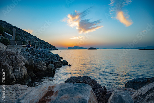 Fototapeta Naklejka Na Ścianę i Meble -  View of the sunset over the Saronic Sea viewed from Kamini harbor on Hydra Island, Greece