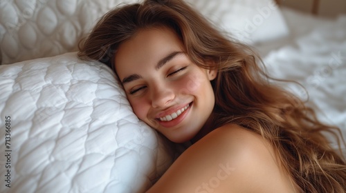 Young woman lying on a cushion with her eyes closed and smiling. Jeune femme allongée sur un coussin avec les yeux fermés et souriante. photo