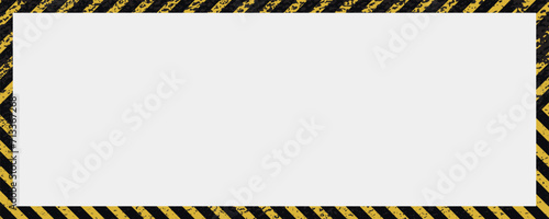 Grunge yellow and black diagonal stripes. Industrial warning background, warn caution, construction, safety. A grungy and worn hazard stripes texture.