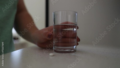 Dietary supplement Caucasian young woman hand holding medical pill capsule, take or eat vitamin. Sick female taking medicines drinking with water at home, pharmacy and healthcare. Close up High