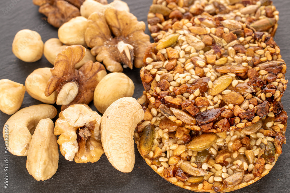 Fototapeta premium Several Thaler cookies with nuts on slate stone, macro.
