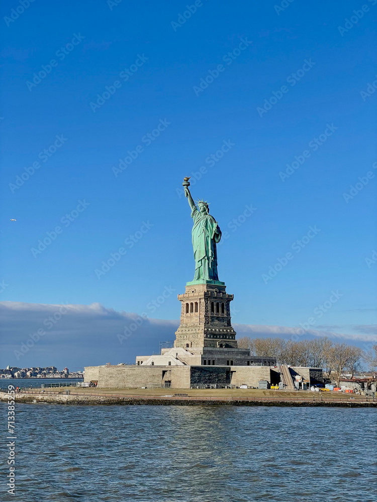 New York, New York – January 11, 2024: the view of the Statue of Liberty from the ferry boat with tourists New York, New York – January 11, 2024: the view of the Statue of Liberty from the ferry boat with tourists