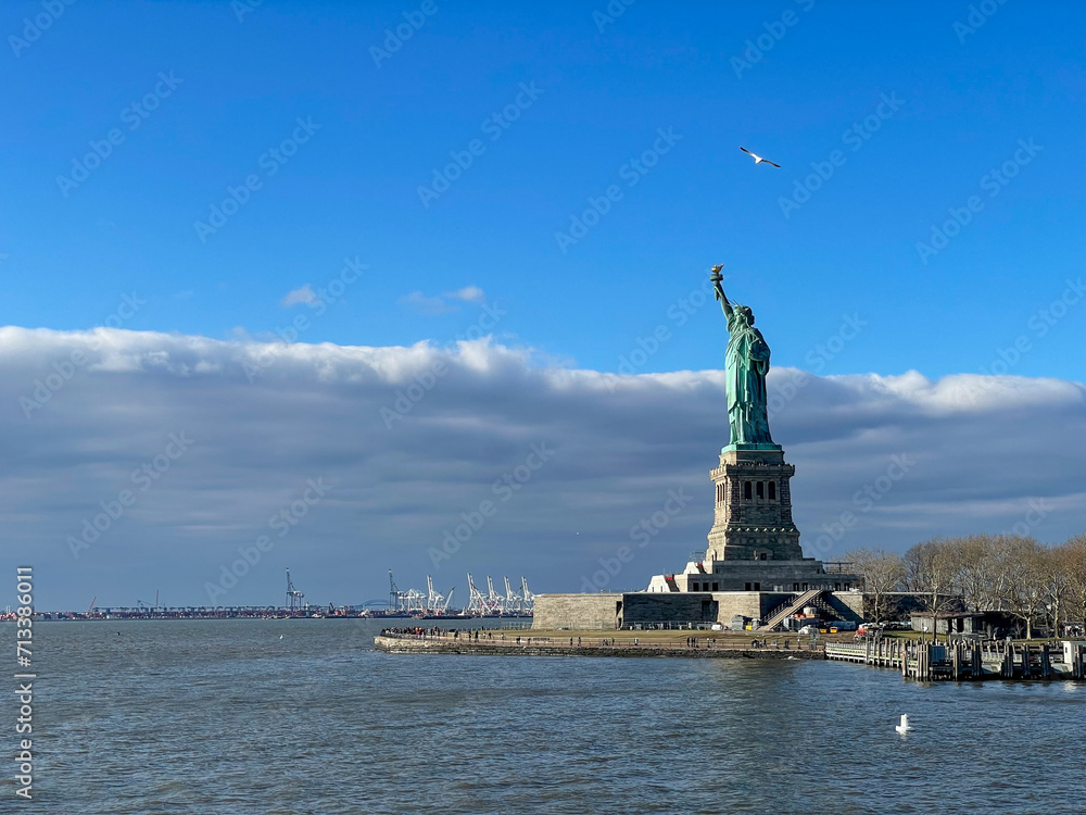New York, New York – January 11, 2024: the view of the Statue of Liberty from the ferry boat with tourists New York, New York – January 11, 2024: the view of the Statue of Liberty from the ferry boat with tourists