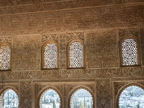 Arabic carved stone arabesque design over windows in the Alhambra palace of Granada, Andalusia