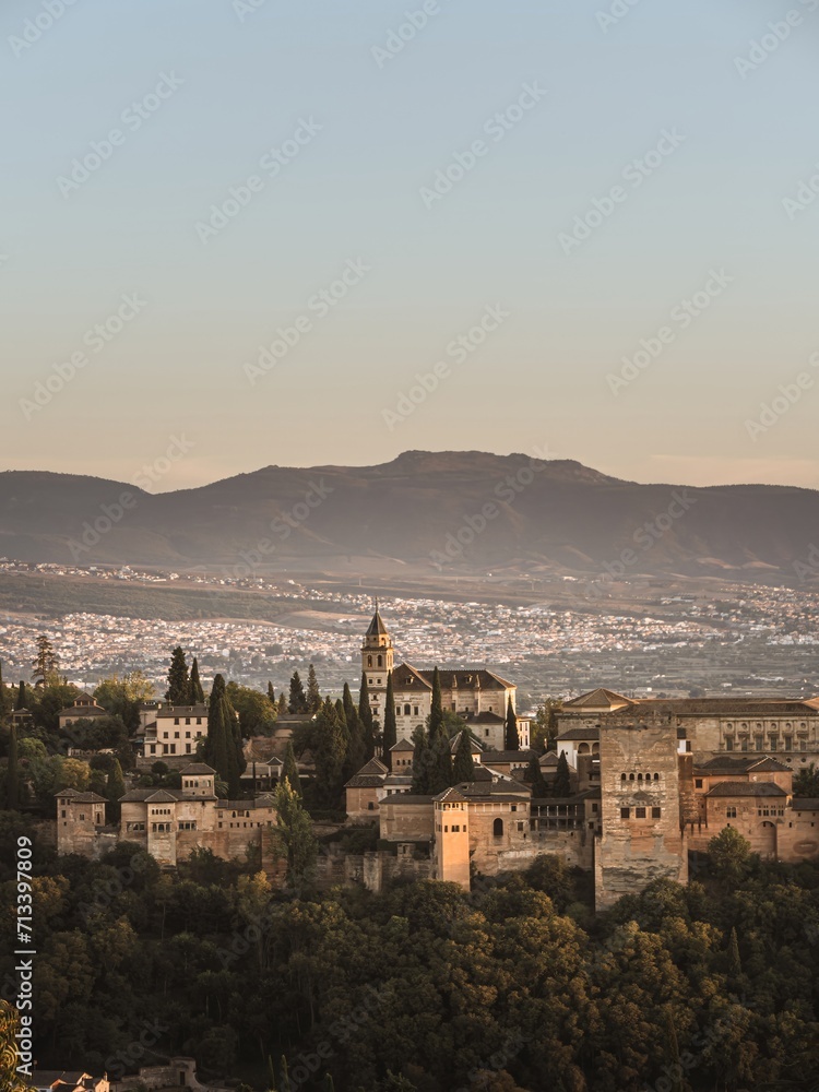 The Nasrid palaces part of the castle Alhambra in Granada, Andalusia, Spain, during sunset, from the Mirador de la Cruz de Rauda