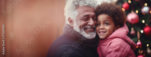Fotografia gray haired Caucasian grandfather with a beard hugs his African American grandso