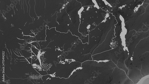 Zambia outlined. Grayscale elevation map photo
