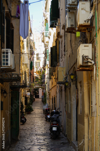 Romantic backstreet, side street or alleys in historic old town of Corfu Island, Greece with Mediterranean style architecture facades, a landmark sightseeing tourist spot in downtown Aegean Sea