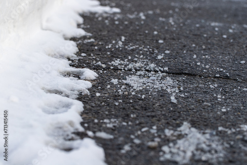 Fototapeta Naklejka Na Ścianę i Meble -  Close up of road with salt for melting snow in winter.