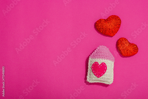 Handmade Valentines Day concept. Creative house figurines  traditional hearts  spring crocheting