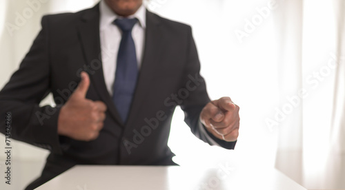 Businessman showing a new goals concept ,blur man fingers on focus.