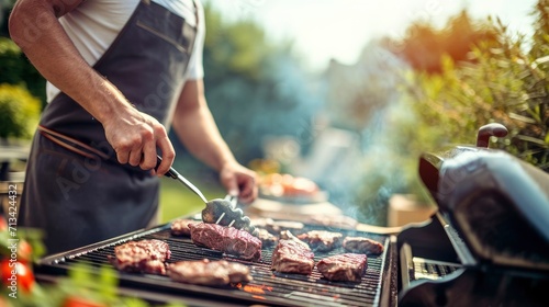 Unrecognizable man cooking beef on a barbecue grill in the backyard photo
