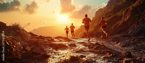 Fitness exercise and couple running in nature by a mountain training for a race marathon or competition Sports health and athletes or runners doing an outdoor cardio workout together at sunset