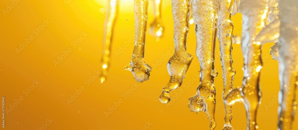 Icicles on a yellow background. Copy space image. Place for adding text Icicles on a yellow background. Copy space image. Place for adding text
