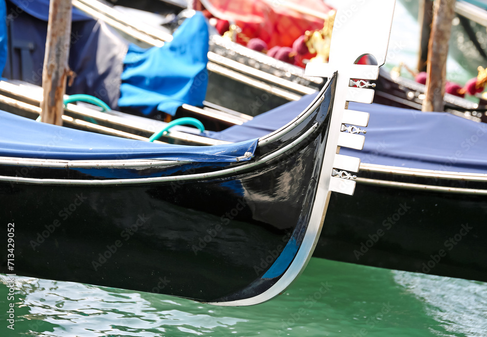 bow of the boat to transport tourists to Venice in Italy called Gondola moored
