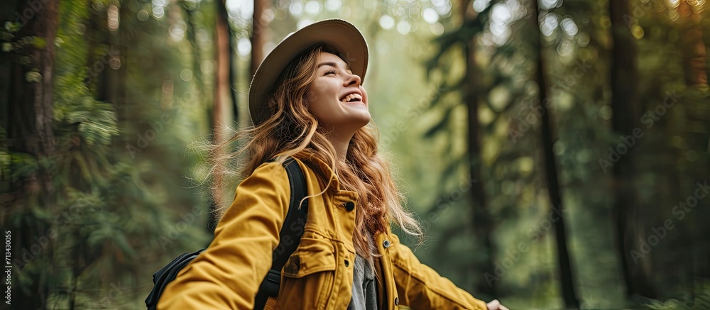 Sustainable eco friendly fashion clothes woman feeling free with open arms in woods forest happy breating clean air Travel tourist girl walking in natural healthy environment renewable resource - obrazy, fototapety, plakaty 