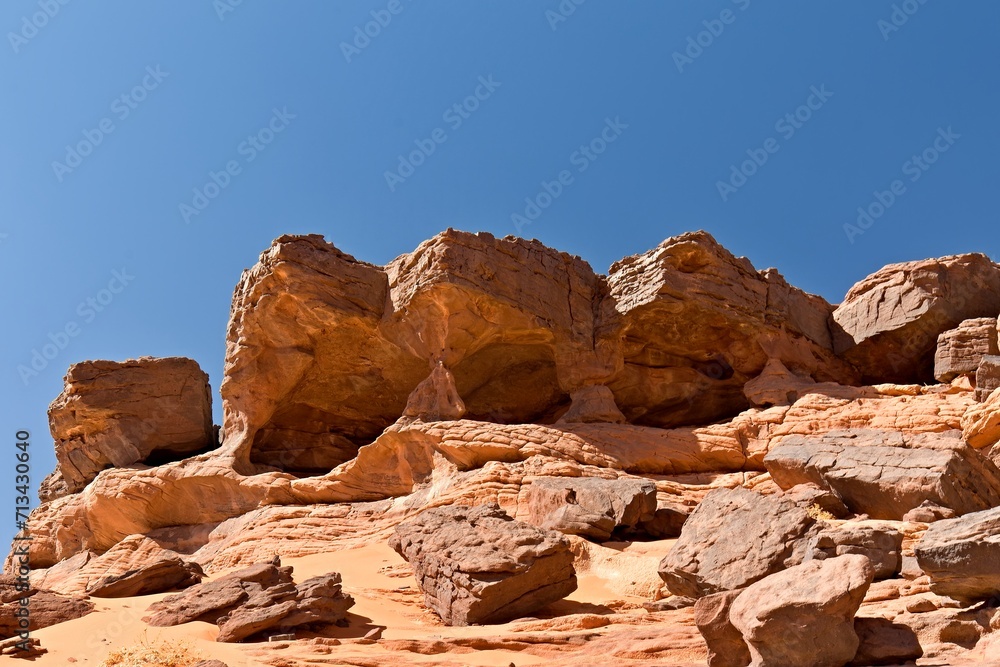 A view of the rock formations in the Tadrart Rouge Mountains. Tassili n Ajjer National Park, Sahara Desert, Algeria, Africa.