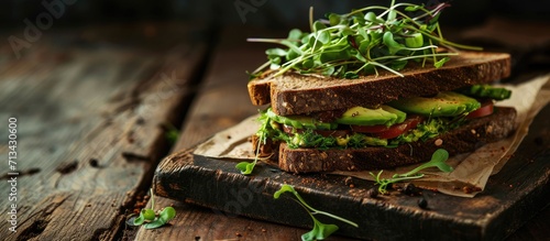 healthy rye sandwich with avocado cucumber alfalfa sprouts. Copy space image. Place for adding text photo