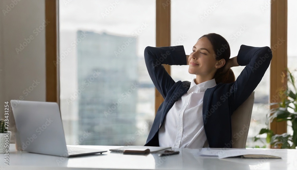 Calm businesswoman office worker holding hands behind head finished computer work at workplace.ai generated Calm businesswoman office worker holding hands behind head finished computer work at workplace.ai generated