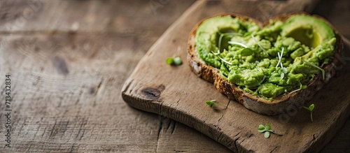 heart shaped healthy avocado toast for valentine day breakfast. Copy space image. Place for adding text