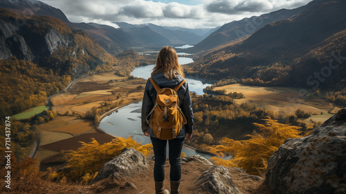 Woman tourist hiking alone in mountains Norway, girl backpacker enjoying clouds view adventure vacations healthy lifestyle outdoor. Woman hiker sits, relaxes and enjoys the views