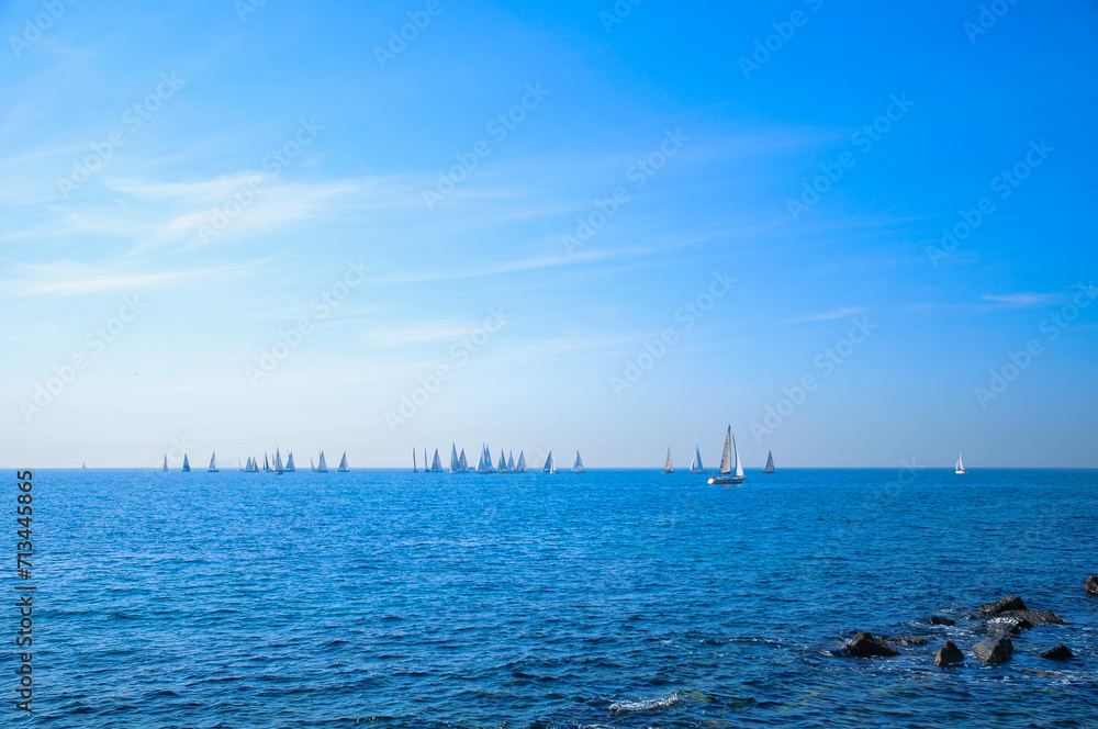 Sailing boats on the horizon.