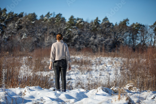 Young woman walking on a mountain snow trail in winter © meegi