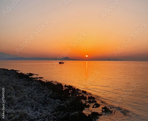 Beautiful red unset over the sea and mountains. Serenity sunset in Greece, Crete © Marina