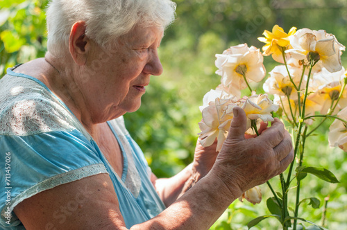 Senior grey haired woman sitting on bench outdoors