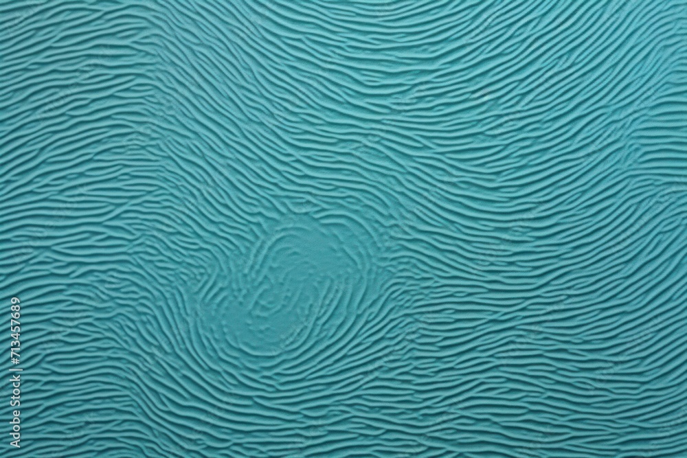  a close up of a blue surface with wavy lines and a circular object in the middle of the image with a green background.