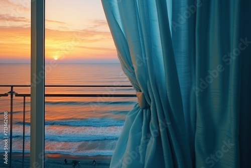  the sun is setting over the ocean as seen from the balcony of a hotel room with a view of the ocean.
