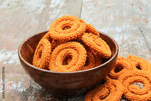 Murukku in a wooden bowl close-up view 