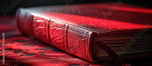 An open book with a red cover in hand close up. Copy space image. Place for adding text or design