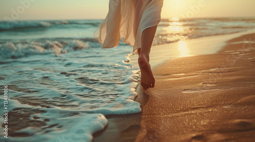 A woman walking barefoot on the sand on the seashore. A sunny summer morning
